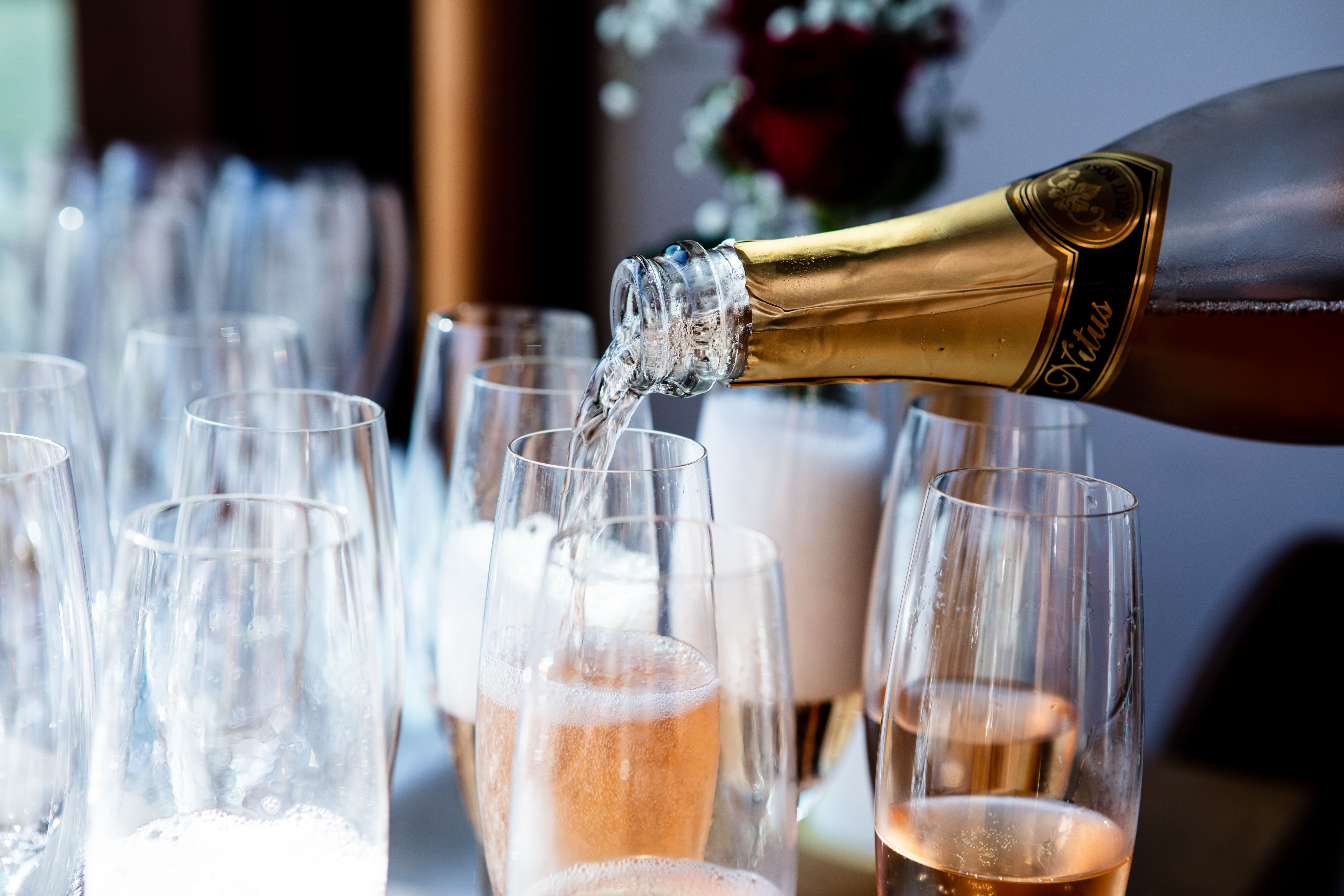 Champagne poured into flute glasses for a luxury Christmas celebration in an arctic lodge