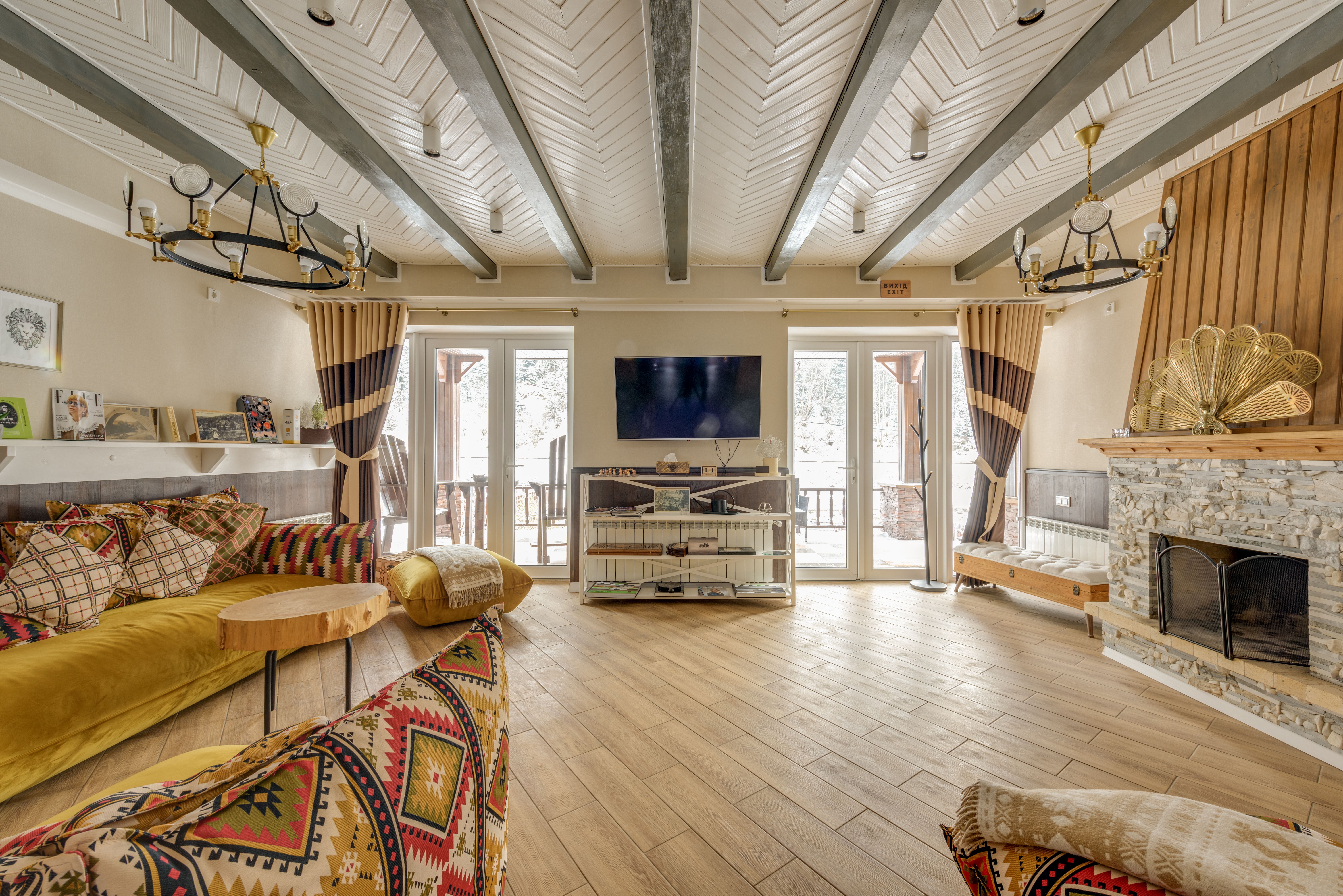 Inviting luxury chalet interior with rustic decor and a large stone fireplace for a warm arctic retreat